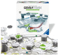 Ravensburger GraviTrax interactive track system starter set, showing the product box, loose gray track pieces, and a built section of the white, gray, and green marble run tracks with marbles on a white background.