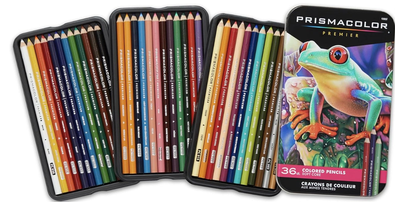 A set of 36 Prismacolor Premier colored pencils arranged in three trays next to their original packaging box featuring a colorful tree frog illustration.